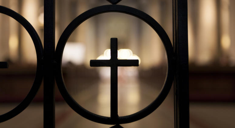 Crucifix shape shilhuette with brighlt light in the background Church Generic