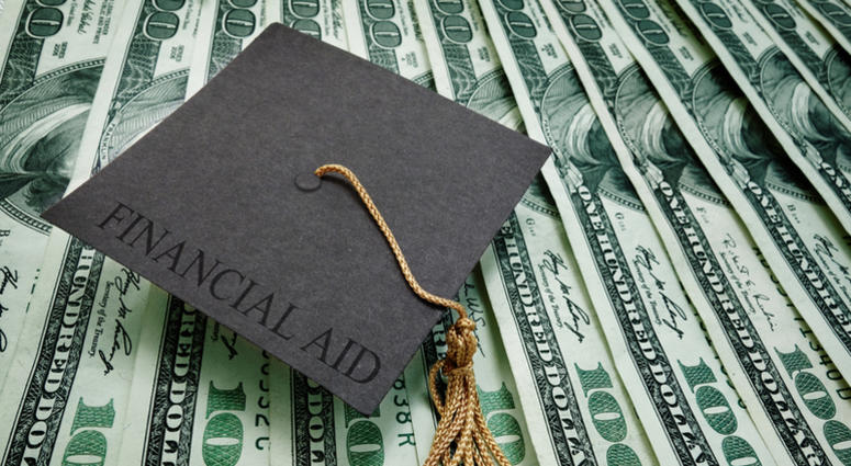 Graduation cap with Financial Aid text on assorted hundred dollar bills Financial Aid