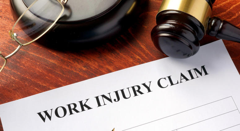 Work injury claim form on a table. Work Injury Claim