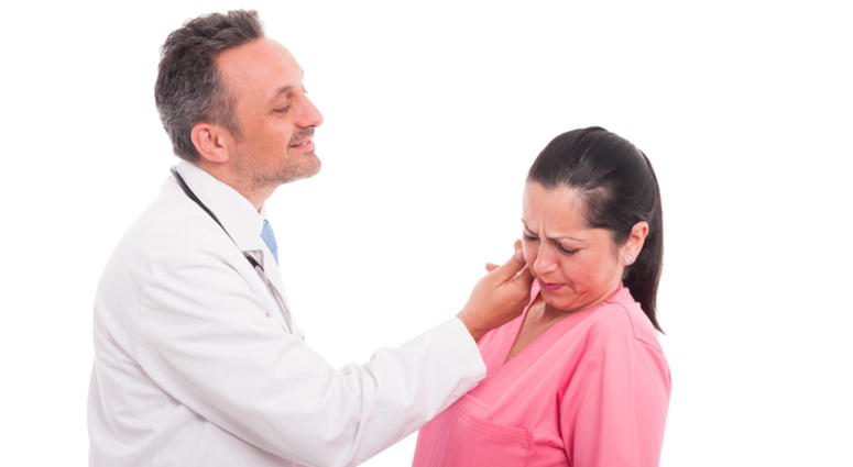 Harassment at work with a medic or doctor touching the face of a female nurse colleague. Sexual Harassment