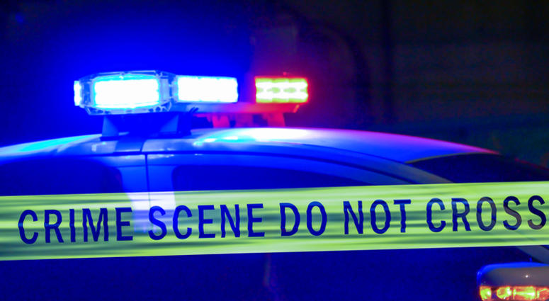 Close-up on siren on police car flashing, with crime scene boundary tape Police Tape Generic