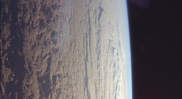Astronaut Michael Collins took this photo of the cloud-speckled Earth, looking east towards the Sun. Astronaut Michael Collins took this photo of the cloud-speckled Earth, looking east towards the Sun.