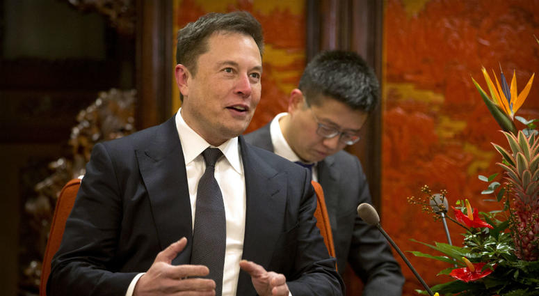 In this Jan. 9, 2019, file photo, Tesla CEO Elon Musk speaks during a meeting with Chinese Premier Li Keqiang at the Zhongnanhai leadership compound in Beijing. In this Jan. 9, 2019, file photo, Tesla CEO Elon Musk speaks during a meeting with Chinese Premier Li Keqiang at the Zhongnanhai leadership compound in Beijing.