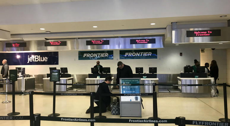 The Frontier Airlines check-in counter is shown at Philadelphia International Airport. The Frontier Airlines check-in counter is shown at Philadelphia International Airport.