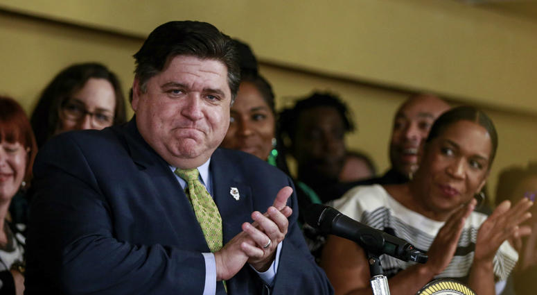 Gov. J. B. Pritzker takes in the applause before signing a bill that legalizes adult-use cannabis in the state of Illinois at Sankofa Cultural Arts and Business Center in Chicago. Gov. J. B. Pritzker takes in the applause before signing a bill that legalizes adult-use cannabis in the state of Illinois at Sankofa Cultural Arts and Business Center in Chicago.