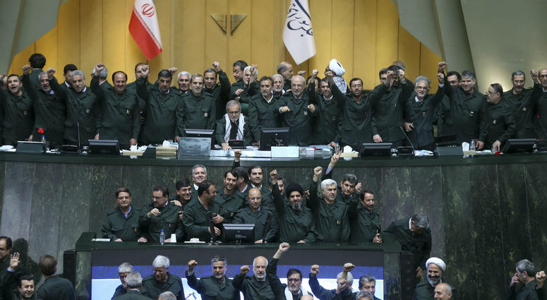 Wearing the uniform of the Iranian Revolutionary Guard, lawmakers chant slogans during an open session of parliament in Tehran, Iran, Tuesday, April 9, 2019. Wearing the uniform of the Iranian Revolutionary Guard, lawmakers chant slogans during an open session of parliament in Tehran, Iran, Tuesday, April 9, 2019.