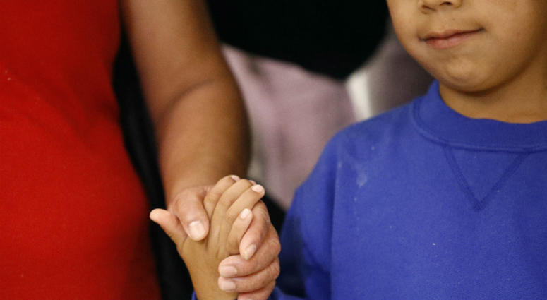 In this Friday, June 22, 2018, file photo, a mother, left, and son, from Guatemala, hold hands during a news conference following their reunion in Linthicum, Md., after being reunited following their separation at the U.S. border. In this Friday, June 22, 2018, file photo, a mother, left, and son, from Guatemala, hold hands during a news conference following their reunion in Linthicum, Md., after being reunited following their separation at the U.S. border.