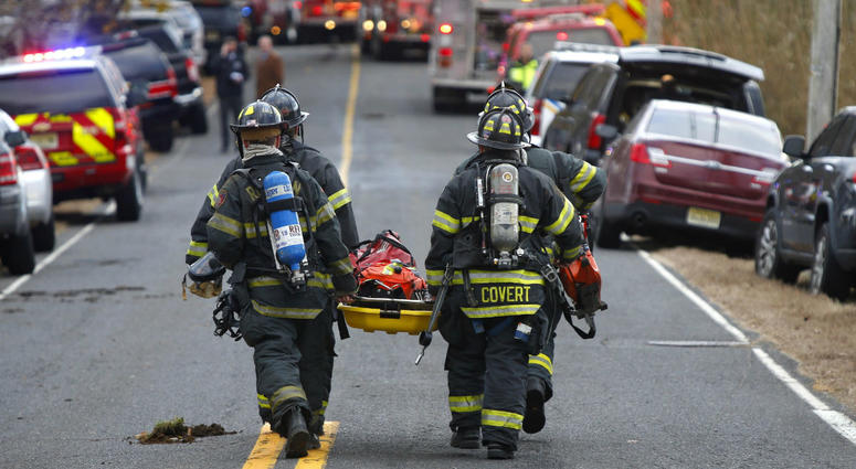 Firefighters carry a stretcher to the scene of a fatal fire at 15 Willow Brook Rd. Tuesday, Nov. 20, 2018, in Colts Neck,N.J. Firefighters carry a stretcher to the scene of a fatal fire at 15 Willow Brook Rd. Tuesday, Nov. 20, 2018, in Colts Neck,N.J.