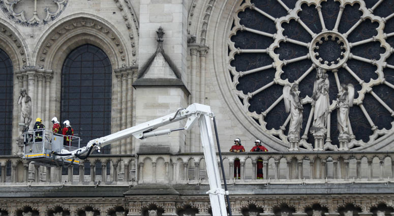 Firefighters work at the facade of Notre Dame cathedral Tuesday April 16, 2019 in Paris. Firefighters work at the facade of Notre Dame cathedral Tuesday April 16, 2019 in Paris.