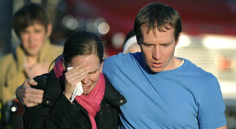 In this Dec. 14, 2012 file photo, Alissa Parker grieves with her husband, Robbie, as they leave a staging area after receiving word that their daughter, Emilie, was one of the 20 children killed in the Sandy Hook School shooting in Newtown, Conn. In this Dec. 14, 2012 file photo, Alissa Parker grieves with her husband, Robbie, as they leave a staging area after receiving word that their daughter, Emilie, was one of the 20 children killed in the Sandy Hook School shooting in Newtown, Conn.