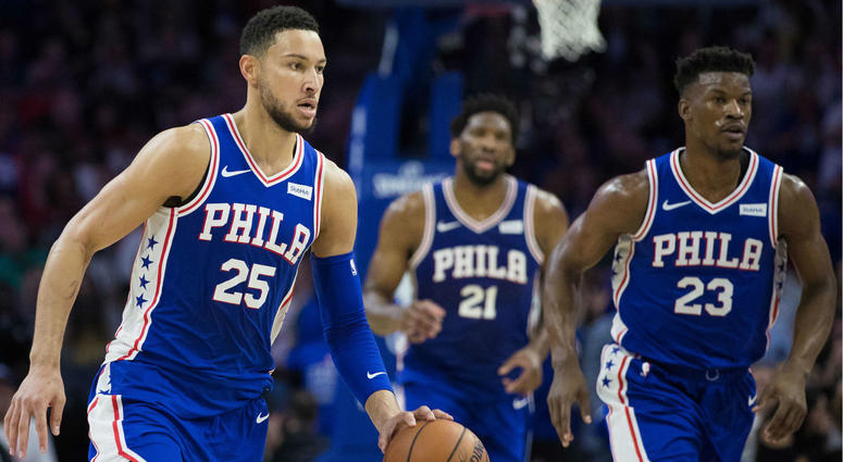 Philadelphia 76ers guard Ben Simmons (25) dribbles up court in front of guard Jimmy Butler (23) and center Joel Embiid (21) during the second quarter against the Boston Celtics at Wells Fargo Center. Philadelphia 76ers guard Ben Simmons (25) dribbles up court in front of guard Jimmy Butler (23) and center Joel Embiid (21) during the second quarter against the Boston Celtics at Wells Fargo Center.