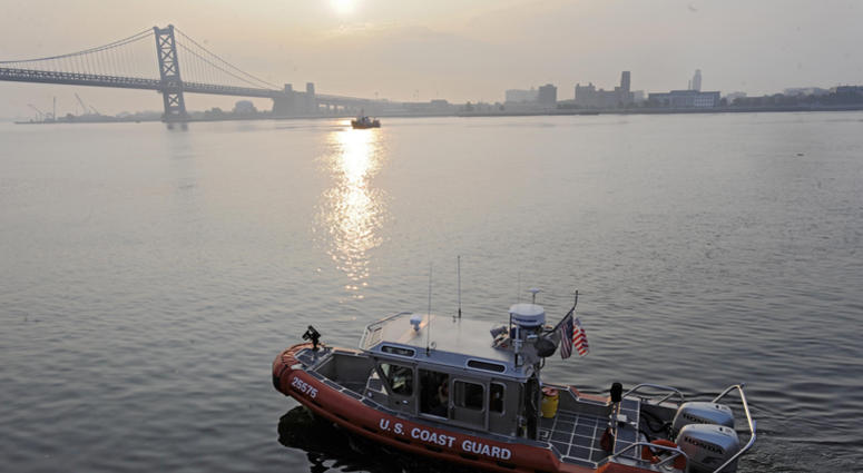 A U.S. Coast Guard boat cruises the Delaware River at Penn's Landing. A U.S. Coast Guard boat cruises the Delaware River at Penn's Landing.