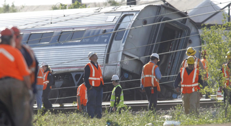 Investigators examine the train derailment site on Wednesday, May 13, 2015, after a northbound Amtrak train crashed in the Port Richmond area of Philadelphia. Investigators examine the train derailment site on Wednesday, May 13, 2015, after a northbound Amtrak train crashed in the Port Richmond area of Philadelphia.