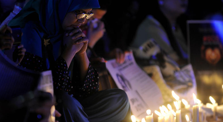 A woman attends a candle lightening rally to protest againts sexual violence in Jakarta, Indonesia, May 13, 2016. A woman attends a candle lightening rally to protest againts sexual violence in Jakarta, Indonesia, May 13, 2016.