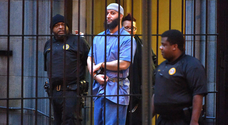 Officials escort "Serial" podcast subject Adnan Syed from the courthouse on Feb. 3, 2016, following the completion of the first day of hearings for a retrial in Baltimore, Maryland. Adnan Syed