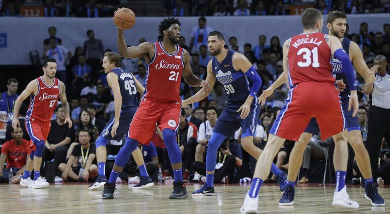 Joel Embiid of the Philadelphia 76ers (21) controls the ball away from Salah Mejri of Dallas Mavericks during the Shenzhen basketball match, part of the NBA China Games, in Shenzhen city, Monday, Oct. 8, 2018. Joel Embiid of the Philadelphia 76ers (21) controls the ball away from Salah Mejri of Dallas Mavericks during the Shenzhen basketball match, part of the NBA China Games, in Shenzhen city, Monday, Oct. 8, 2018.