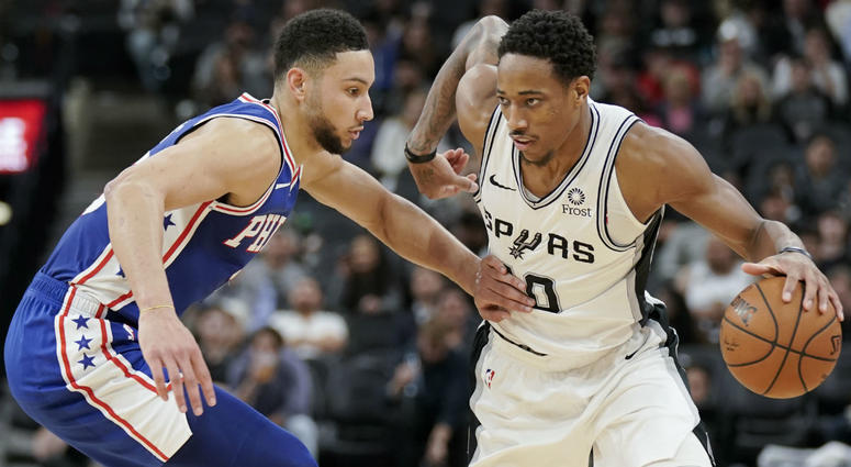 San Antonio Spurs' DeMar DeRozan, right, drives against Philadelphia 76ers' Ben Simmons during the second half of an NBA basketball game, Monday, Dec. 17, 2018, in San Antonio. San Antonio Spurs' DeMar DeRozan, right, drives against Philadelphia 76ers' Ben Simmons during the second half of an NBA basketball game, Monday, Dec. 17, 2018, in San Antonio.