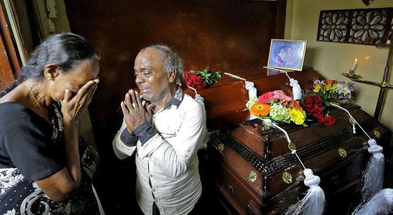 A Sri Lankan family mourns next to the coffins of their three family member, all victims of Easter Sunday bombing, in Colombo, Sri Lanka, Tuesday, April 23, 2019. A Sri Lankan family mourns next to the coffins of their three family member, all victims of Easter Sunday bombing, in Colombo, Sri Lanka, Tuesday, April 23, 2019.