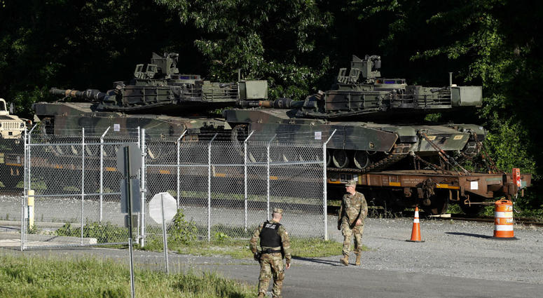 Military police walk near Abrams tanks on a flat car in a rail yard, Monday, July 1, 2019, in Washington, ahead of a Fourth of July celebration that President Donald Trump says will include military hardware. Military police walk near Abrams tanks on a flat car in a rail yard, Monday, July 1, 2019, in Washington, ahead of a Fourth of July celebration that President Donald Trump says will include military hardware.