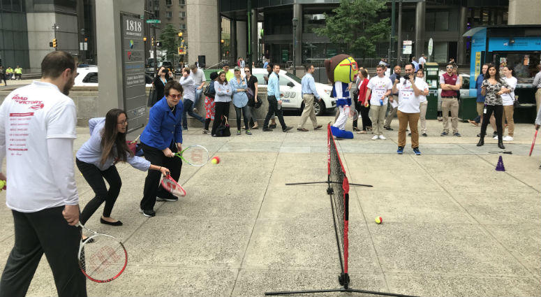 Tennis legend Billie Jean King helps passersby with their swing in Center City Philadelphia. Billie Jean King tennis clinic in center City Philadelphia