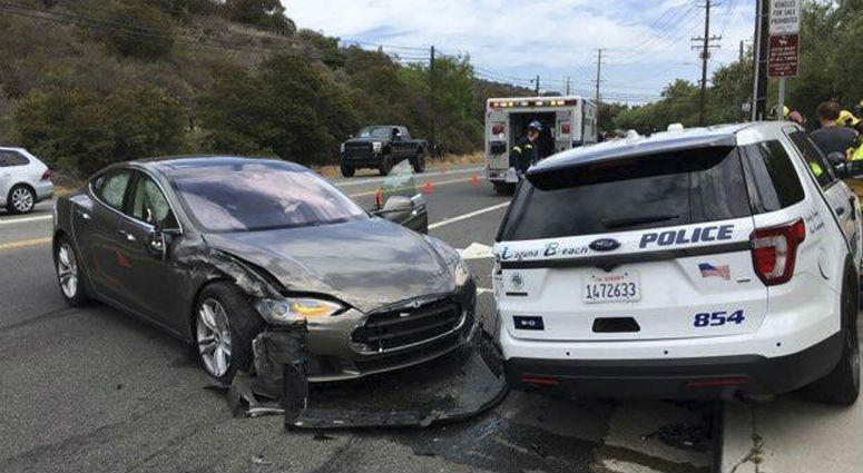 This photo provided by the Laguna Beach Police Department shows a Tesla sedan, left, in autopilot mode that crashed into a parked police cruiser Tuesday, May 29, 2018, in Laguna Beach, Calif. a Tesla sedan, left, in autopilot mode that crashed into a parked police cruiser