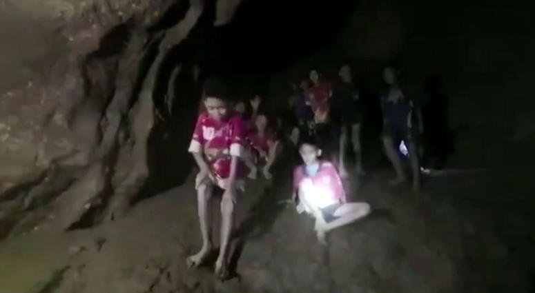 In this image taken from video provided by the Thai Navy Seal, a the boys and their soccer coach can be seen in a cave in Chiang Rai in Thailand, Monday, July 2, 2018. In this image taken from video provided by the Thai Navy Seal, a the boys and their soccer coach can be seen in a cave in Chiang Rai in Thailand, Monday, July 2, 2018.