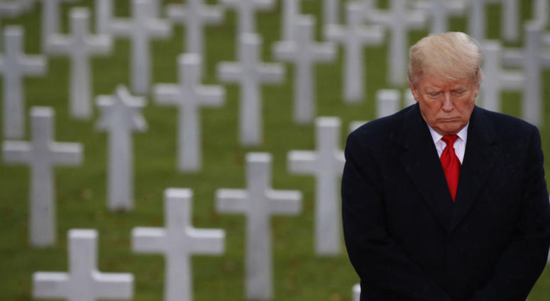 President Donald Trump stands in front of headstones during an American Commemoration Ceremony, Sunday Nov. 11, 2018, at Suresnes American Cemetery near Paris. President Donald Trump stands in front of headstones during an American Commemoration Ceremony, Sunday Nov. 11, 2018, at Suresnes American Cemetery near Paris.
