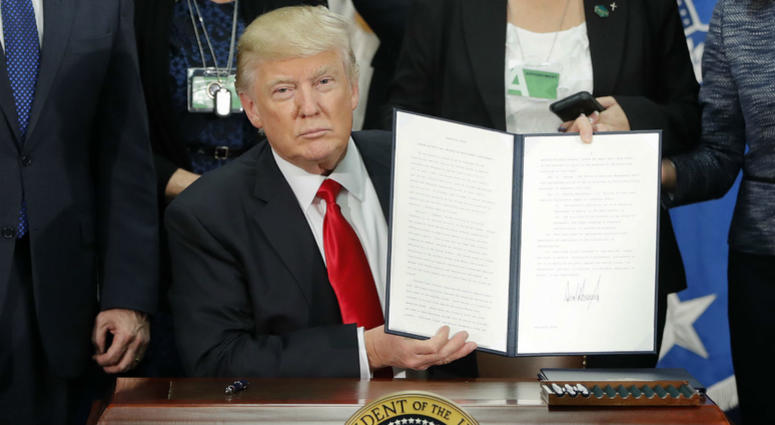 President Donald Trump holds up an executive order for border security and immigration enforcement improvements after signing the order during a visit to the Homeland Security Department headquarters in Washington, on Jan. 25, 2017. President Donald Trump holds up an executive order for border security and immigration enforcement improvements after signing the order during a visit to the Homeland Security Department headquarters in Washington, on Jan. 25, 2017.