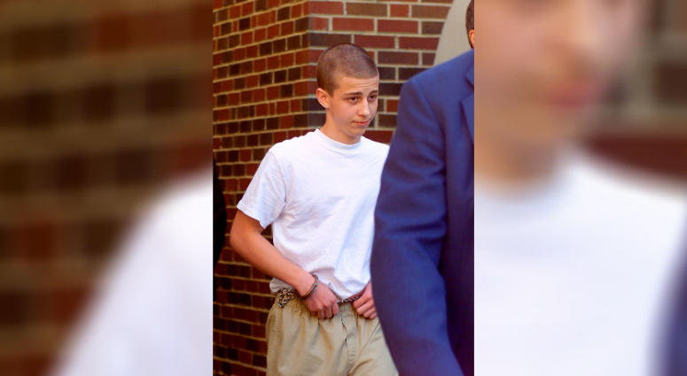 In this April 27, 2000, file photo, convicted Westside Middle School shooter Andrew Golden, 13, is escorted from a back door of the Craighead County Courthouse in Jonesboro, Ark. Andrew Golden