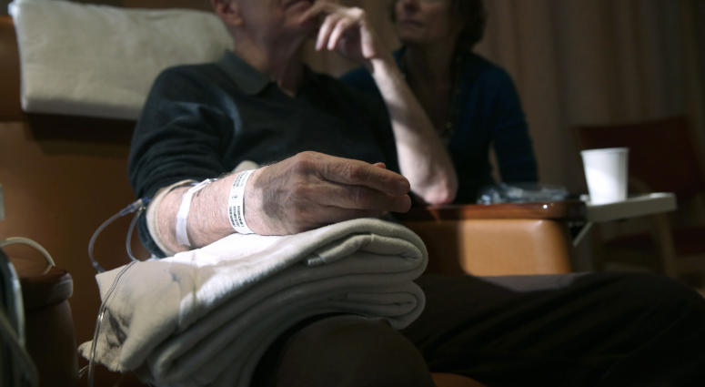 Youssef Cohen, 68, sits while undergoing cancer treatment as his wife Lindsay Wright looks on, on March 17, 2016 in New York City. Cohen has an incurable cancer called mesothelioma and is advocating for the right to choose how and when he will die. Physician-assisted suicide patient