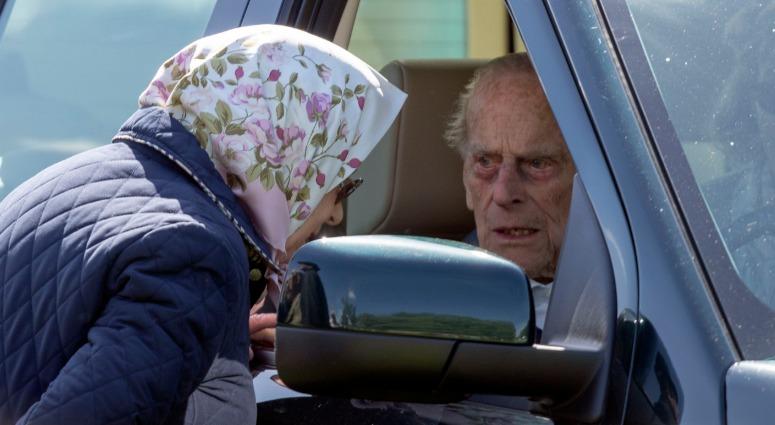 A file photo from Nov. 5, 2018 shows the Duke of Edinburgh, who was "very shocked" and shaken when the Land Rover he was driving was hit by a Kia in January 2019. He is pictured talking to the Queen while at the wheel of a similar vehicle. Duke of Edinburgh