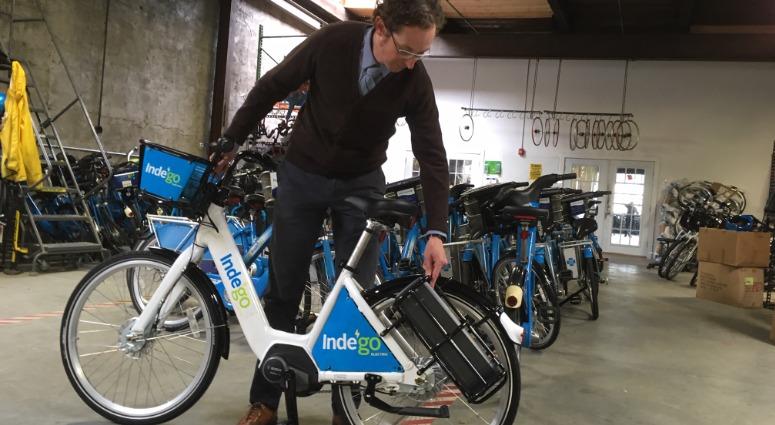 Aaron Ritz, transportation programs manager for the Office of Transportation, Infrastructure, and Sustainability (oTIS) shows off a new Indego electric-assist bike. Aaron Ritz, transportation programs manager for the Office of Transportation, Infrastructure, and Sustainability (oTIS) shows off a new Indego electric-assist bike.