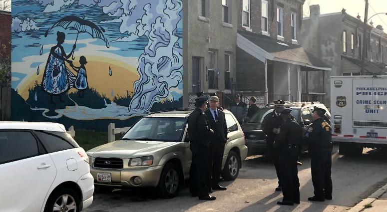 Authorities confer on the scene of a quadruple homicide, where four people were discovered to have been murdered execution style in the basement of a West Philadelphia row home. Authorities confer on the scene of a quadruple homicide, where four people were discovered to have been murdered execution style in the basement of a West Philadelphia row home.
