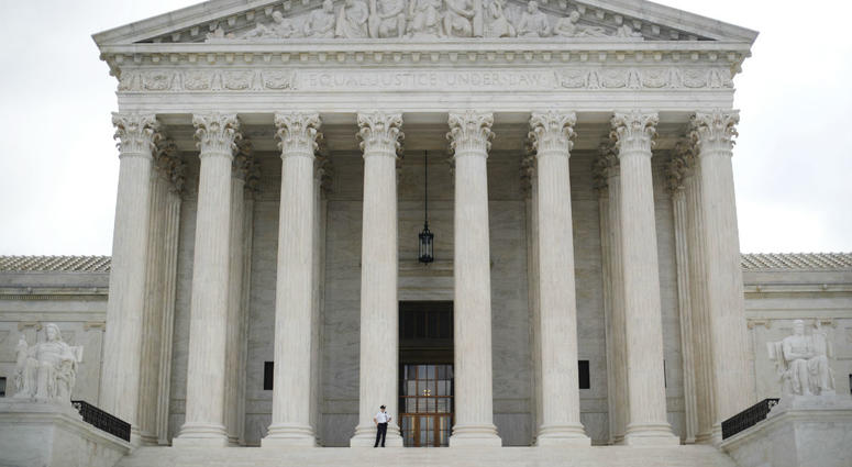 In this Oct. 9, 2018 photo, police office guards the main entrance to the Supreme Court in Washington. In this Oct. 9, 2018 photo, police office guards the main entrance to the Supreme Court in Washington.