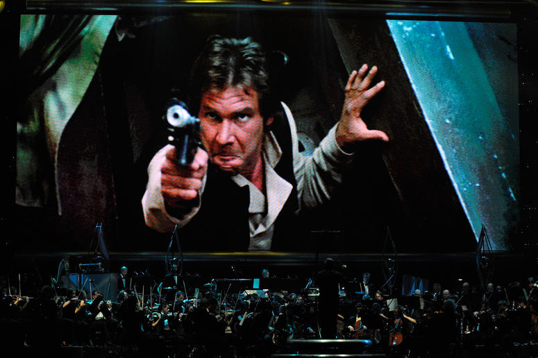 Harrison Ford as Han Solo in 'Star Wars Episode VI: Return of the Jedi' Actor Harrison Ford's Han Solo character from 'Star Wars Episode VI: Return of the Jedi' is shown on screen while musicians perform during 'Star Wars: In Concert' at the Orleans Arena May 29, 2010 in Las Vegas, Nevada. The traveling production features a