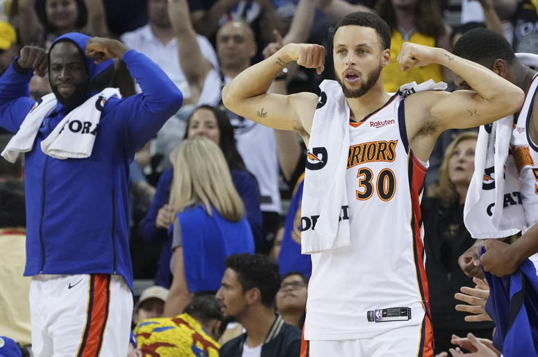 Golden State Warriors' Steph Curry and Draymond Green April 7, 2019; Oakland, CA, USA; Golden State Warriors forward Draymond Green (23) and guard Stephen Curry (30) celebrate on the bench during the fourth quarter against the LA Clippers at Oracle Arena. Mandatory Credit: Kyle Terada-USA TODAY Sports