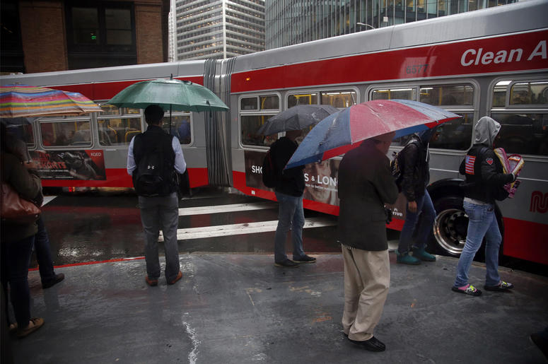 (Photo credit: Karl Mondon/Bay Area News Group/TNS) Bus riders and pedestrians brave the storm with rain pouring down in the Financial District of San Francisco on Friday, Oct. 14, 2016. (Photo by Karl Mondon/Bay Area News Group/TNS)
