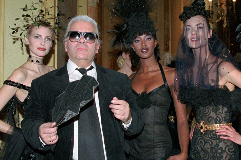 Karl Lagerfeld Karl Lagerfeld is surrounded by Canadian model Linda Evangelista, left, and British model Naomi Campbell, right, and other models after the presentation of his 1996-97 fall-winter haute couture fashion collection for Chanel in Paris.