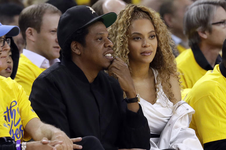 AP18238459163053 In this April 28 2018, file photo Jay-Z and Beyonce watch Game 1 of an NBA basketball second-round playoff series between the Golden State Warriors and the New Orleans Pelicans in Oakland, Calif. Police say they are pursuing more charges against a fan who