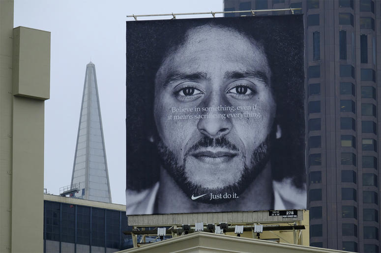 AP18248647284635 A large billboard stands on top of a Nike store showing former San Francisco 49ers quarterback Colin Kaepernick at Union Square, Wednesday, Sept. 5, 2018, in San Francisco. An endorsement deal between Nike and Colin Kaepernick prompted a flood of debate T