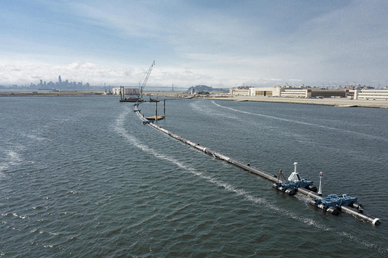 AP18250791823574 In this Monday, Aug. 27, 2018 photo provided by The Ocean Cleanup, a long floating boom that will be used to corral plastic litter in the Pacific Ocean is assembled in Alameda, Calif. Engineers will deploy a trash collection device to corral plastic litte