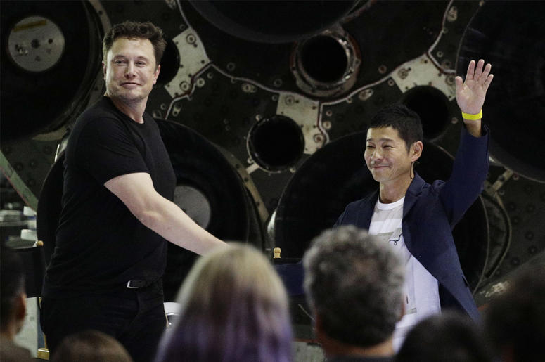 AP18261097654026 SpaceX founder and chief executive Elon Musk, left, shakes hands with Japanese billionaire Yusaku Maezawa, right, after announcing him as the first private passenger on a trip around the moon, Monday, Sept. 17, 2018, in Hawthorne, Calif. (AP Photo/Chris C
