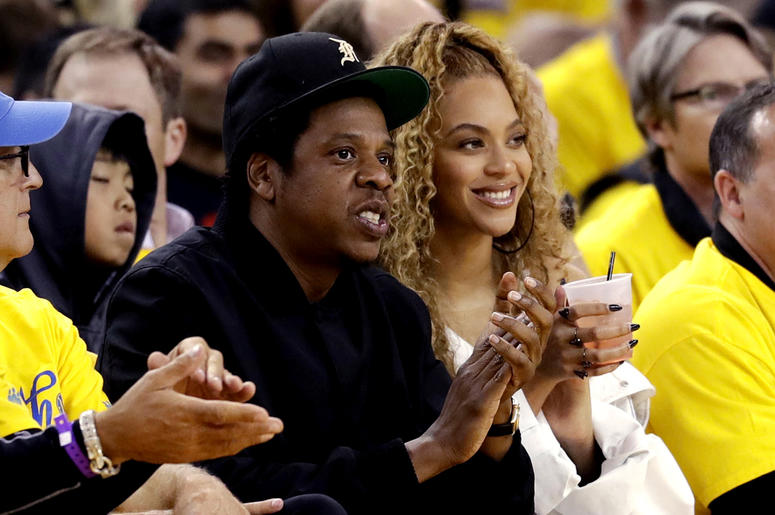AP18285318029743 In this April 28, 2018, file photo, Jay-Z and Beyonce watch Game 1 of an NBA basketball second-round playoff series between the Golden State Warriors and the New Orleans Pelicans in Oakland, Calif. Beyonce paid homage to a high-profile music executive bei
