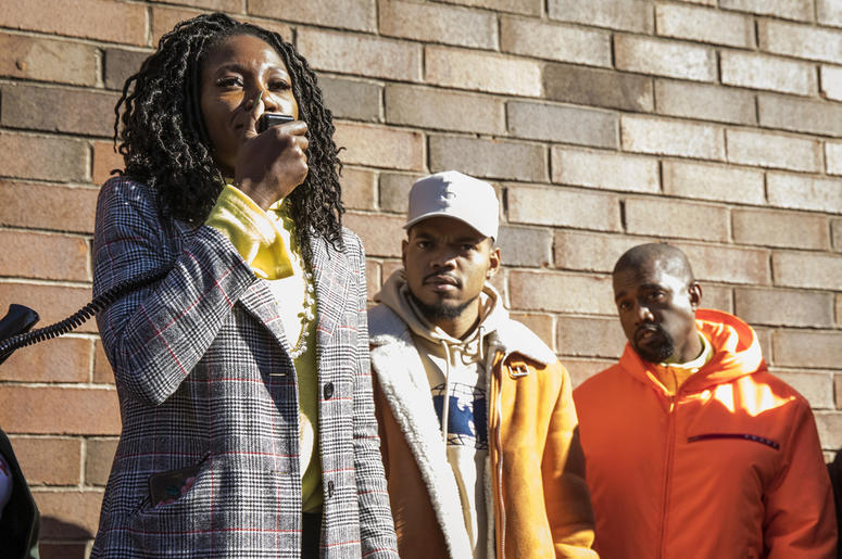 AP18296732137187 Chicago mayoral candidate Amara Enyia speaks as Chance the Rapper, center, and Kanye West listen during a "pull-up" rally for Enyia Tuesday, Oct. 23, 2018, in Chicago. (Ashlee Rezin/Chicago Sun-Times via AP)
