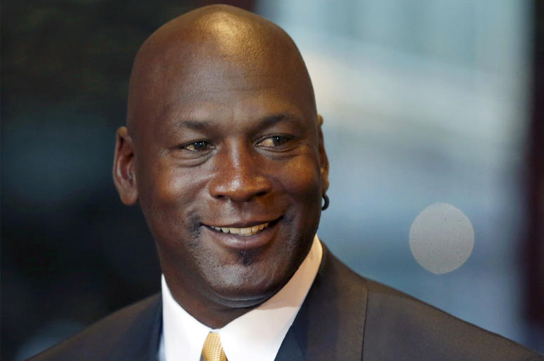AP18298062208236 In this Aug. 21, 2015, file photo, former NBA star and current owner of the Charlotte Hornets, Michael Jordan smiles at reporters in Chicago. A quarter century after being famously excluded from the cult favorite video game NBA Jam, Jordan is investing in