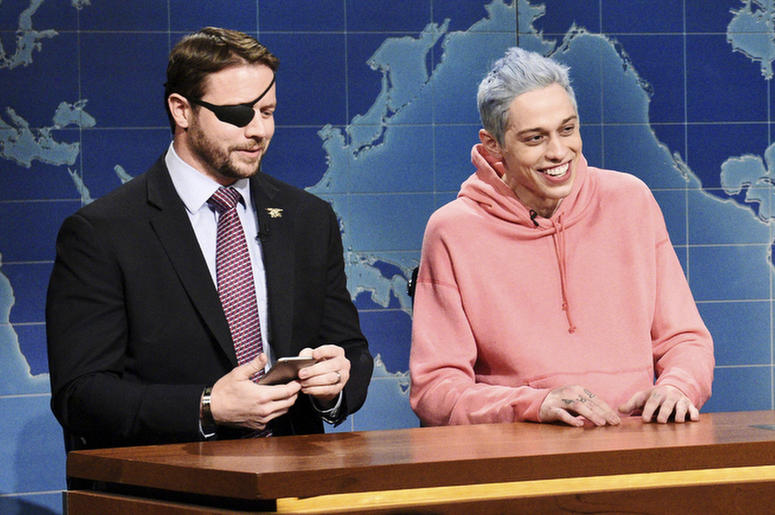 AP18315564956090 In this Nov. 10, 2018 photo provided by NBC, Lt. Com. Dan Crenshaw, from left, a congressman-elect from Texas and Pete Davidson appear during Saturday Night Live’s "Weekend Update" in New York. Davidson made his apologies to Crenshaw whose appearance he m