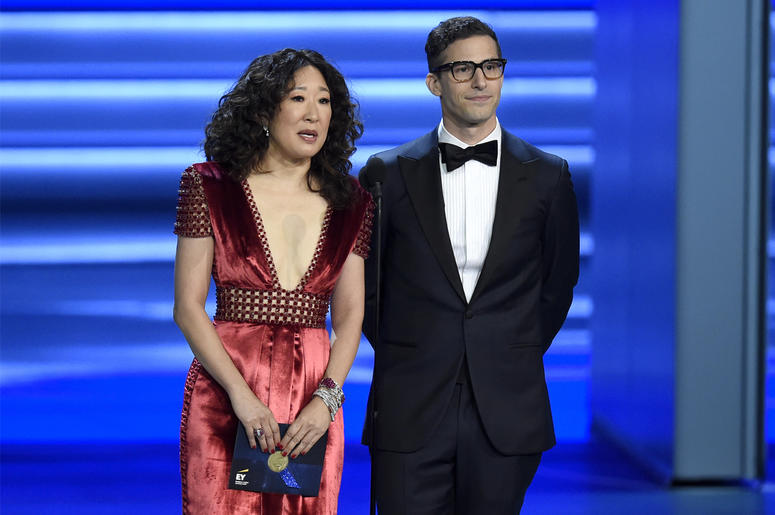 AP18339808369666 In this Sept. 17, 2018 file photo, Sandra Oh, left, and Andy Samberg present an award at the 70th Primetime Emmy Awards in Los Angeles. Oh and Samberg will share host duties at next month’s Golden Globe ceremony. (Photo by Chris Pizzello/Invision/AP, File