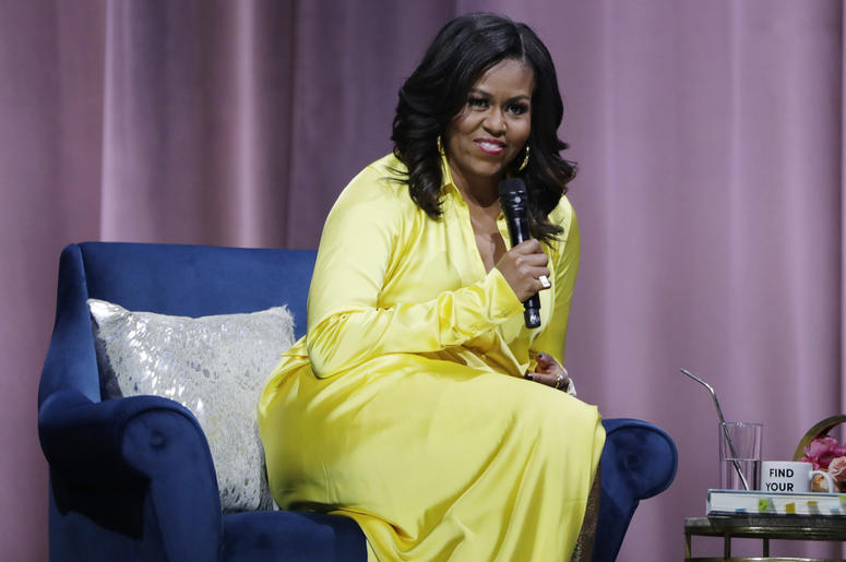 AP18354083595350 Former first lady Michelle Obama responds to questions as she is interviewed by actress Sarah Jessica Parker during an appearance for her book, "Becoming: An Intimate Conversation with Michelle Obama" at Barclays Center Wednesday, Dec. 19, 2018, in New Yo