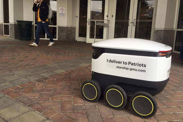 AP19023637811733 A Starship robot stands by at George Mason University campus in Fairfax, Va., Wednesday, Jan. 23, 2019. A fleet of high-tech robots is now deployed at the northern Virginia university to serve the noble purpose of delivering pizza, doughnuts and coffee on