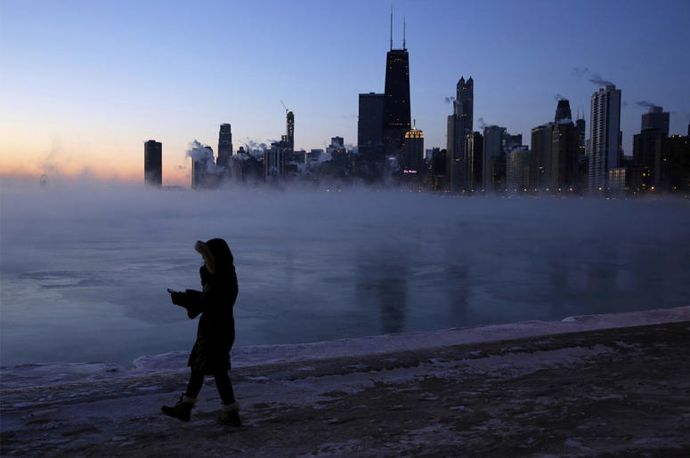 AP19030538683051 A person walks along the lakeshore, Wednesday, Jan. 30, 2019, in Chicago. A deadly arctic deep freeze enveloped the Midwest with record-breaking temperatures on Wednesday, triggering widespread closures of schools and businesses, and prompting the U.S. Po